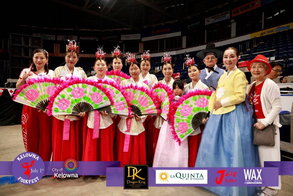 Paul Lauzon and his wife with Korean cultural performers at Kelowna Folkfest 2026