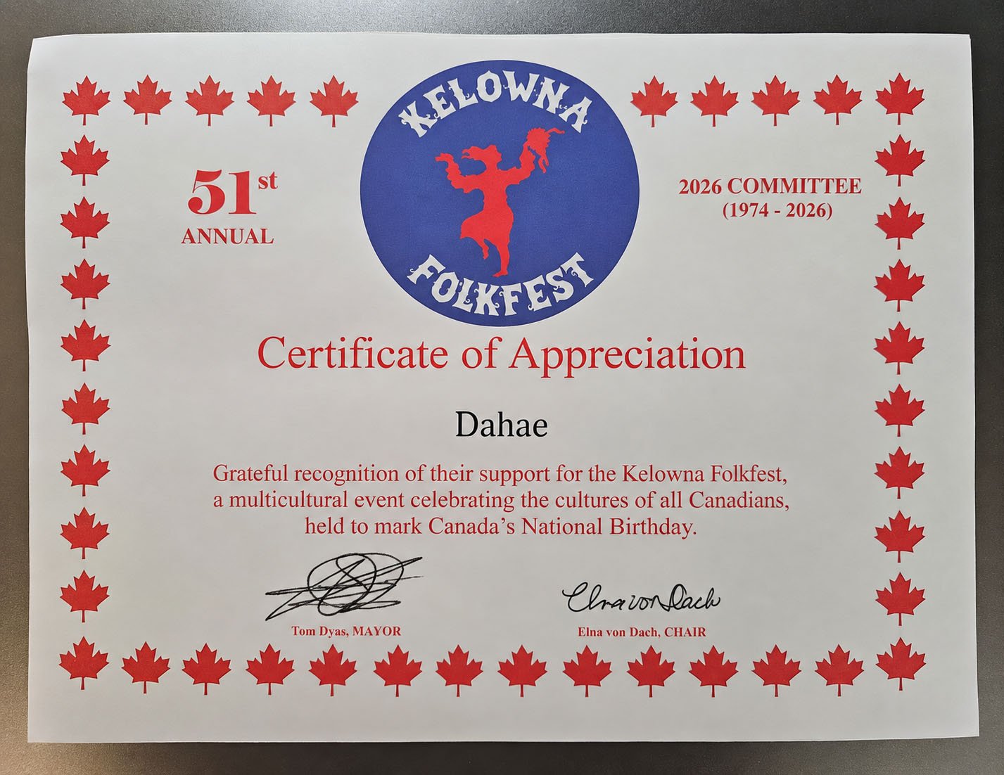 Kelowna Folkfest 2026 Certificate of Appreciation presented to Paul Lauzon’s wife