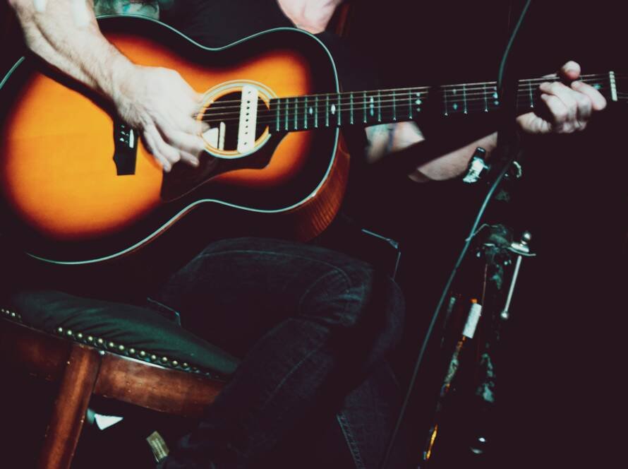 Musician playing an acoustic guitar