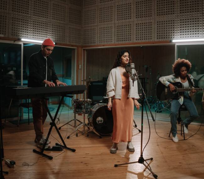 Band performing together during a recording studio session