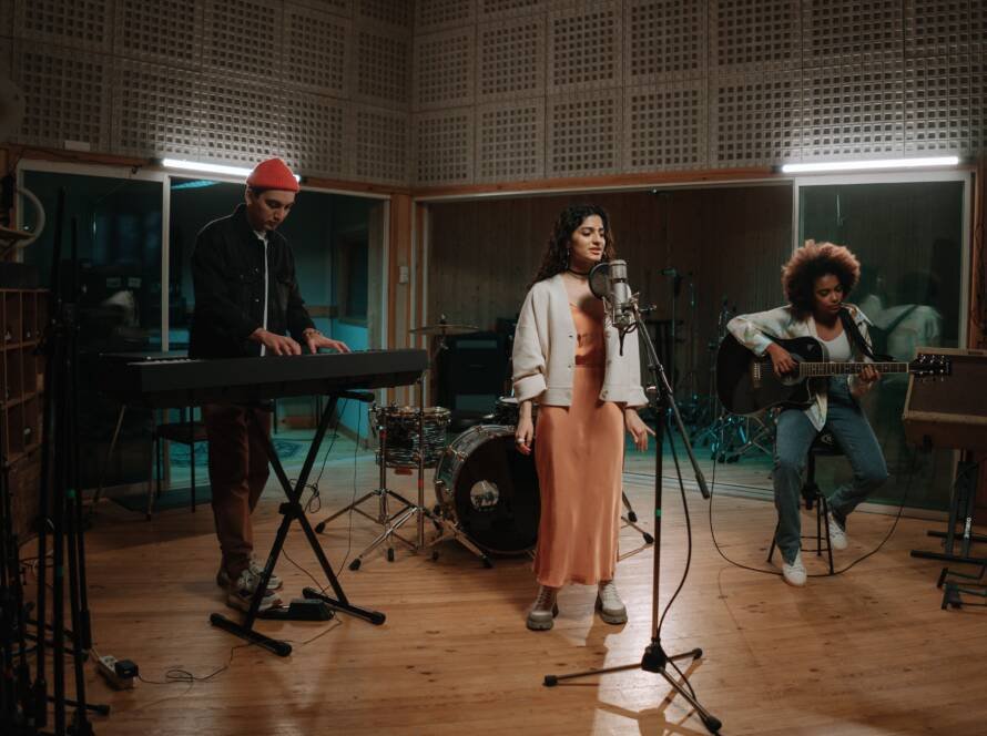Band performing together during a recording studio session