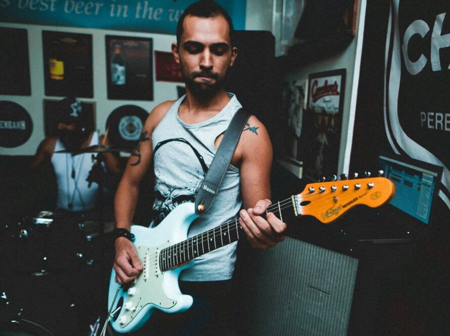 Musician playing electric guitar in a roots rock performance